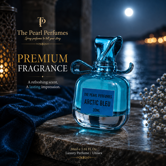 A 30ml bottle of The Pearl Perfumes Arctic Bleu premium fragrance, featuring a translucent blue glass body and a matching blue cap, set against a moody, dark background with a lantern, velvet fabric, and a bright full moon.